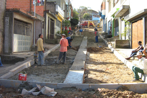 Execução de via em bloco de concreto intertravado e sarjeta central.